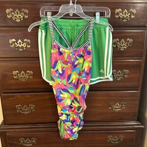 Women’s Dolfin swimsuit, matching Adidas shorts.